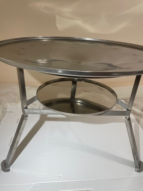 stainless steel round korean grill that can be used with open fire, charcoal, or propane.  Comes with lid and charcoal tray. Legs and handles.  Perfect for cabins, campsites, or any outdoor location.  There is a fire ban, no problem, can be easily used with propane fire.