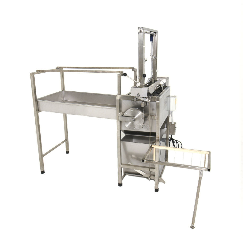 All stainless steel construction, the oscillating blades have hot water circulated through on the inside of them.  Hot water tank holds about 5 L of water.  Digital Temp control.  Counter balanced.  Frame rack holds about 20 frames.