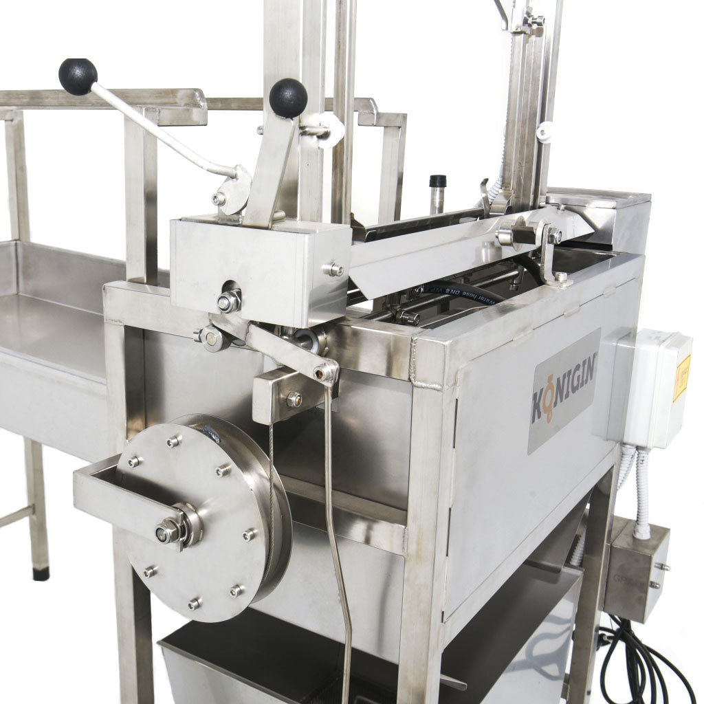All stainless steel construction, the oscillating blades have hot water circulated through on the inside of them.  Hot water tank holds about 5 L of water.  Digital Temp control.  Counter balanced.  Frame rack holds about 20 frames.